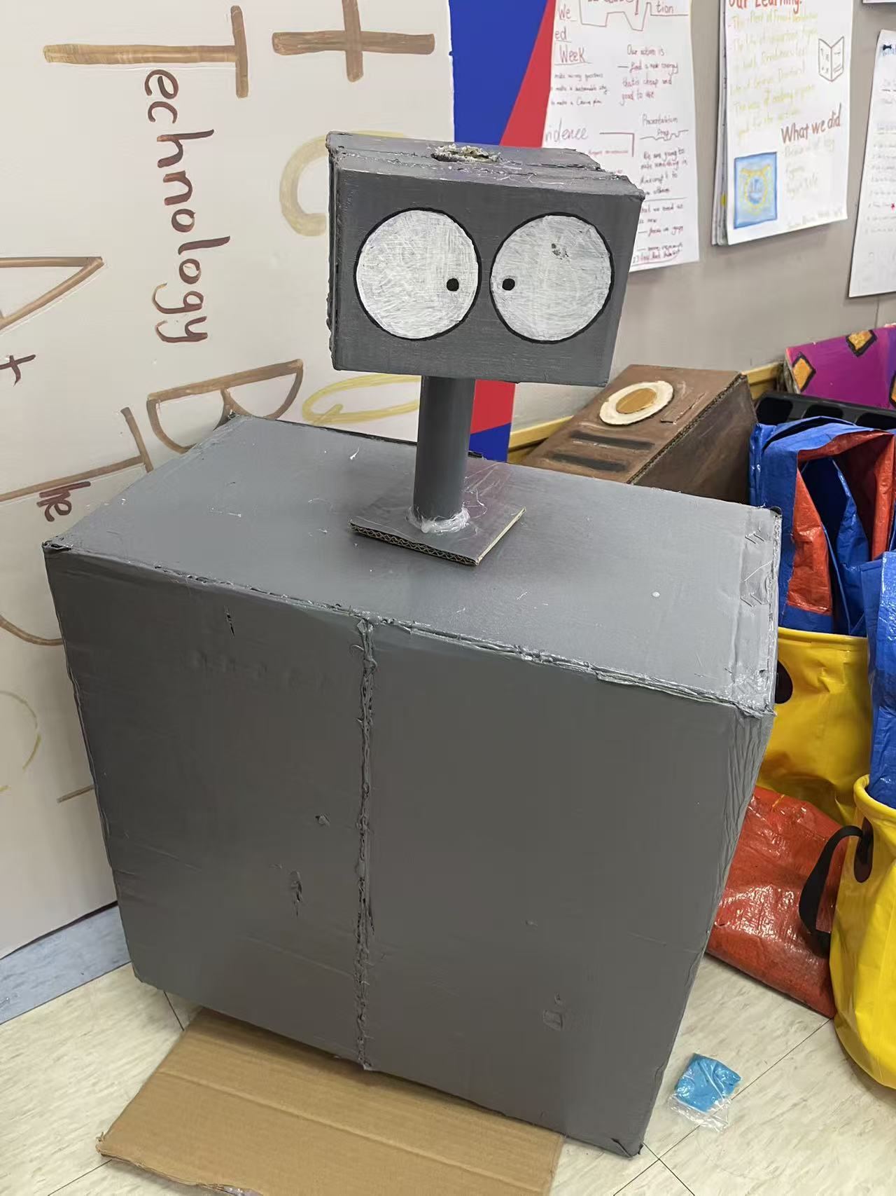 A station robot built from cardboard boxes.